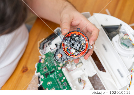 home electronics repair concept. vacuum robot cleaner service center 102010513