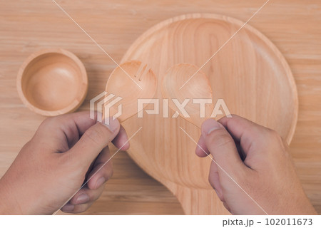 hand holding spoon and fork 102011673