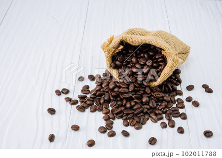 Coffee beans with sack on wooden Coffee beans with sack on wooden 102011788