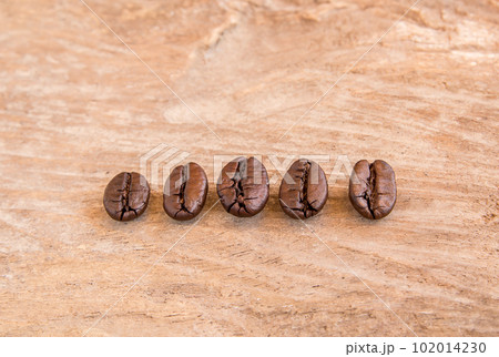 Coffee beans on wooden table background 102014230
