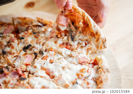 one people taking slices of pizza out of the box. fast delivery of food. packaging for fast food. top view one people taking slices of pizza out of the box. fast delivery of food. packaging for fast food. top view 102015584