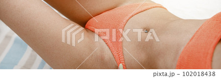 Close up of sexy woman on beach towl in swimsuit with ideal fitness body. Blurred background Close up of sexy woman on beach towl in swimsuit with ideal fitness body. Blurred background 102018438