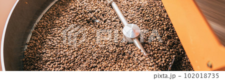 Close up of coffee roasting machine with coffee beans in small coffee manufacturing 102018735