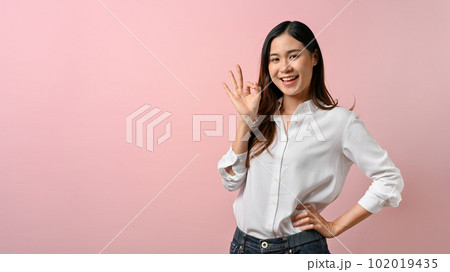 Portrait happy Asian woman shows ok sign on pink isolated background. 102019435