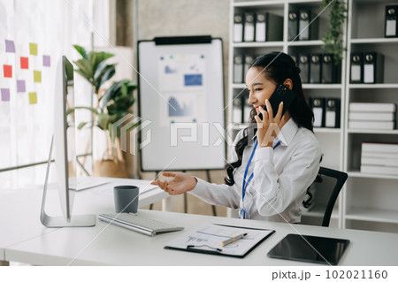 Happy asian business woman have the joy of talking on the smartphone, tablet and laptopon the office .. 102021160