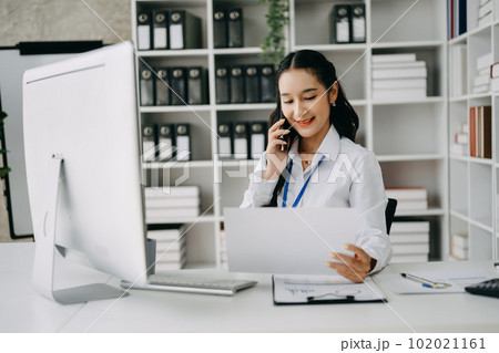 Happy asian business woman have the joy of talking on the smartphone, tablet and laptopon the office .. 102021161