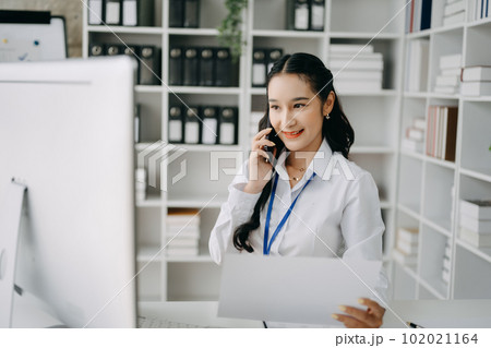 Happy asian business woman have the joy of talking on the smartphone, tablet and laptopon the office .. 102021164