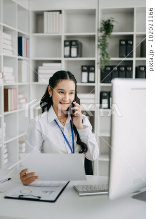 Happy asian business woman have the joy of talking on the smartphone, tablet and laptopon the office .. 102021166