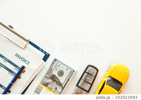 Car Trade or Rent Deal. Invoice, Money and Car Keys on White background. 102023093