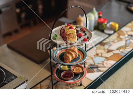 Tray with breakfast at ordering station in open restaurant kitchen Tray with breakfast at ordering station in open restaurant kitchen 102024439