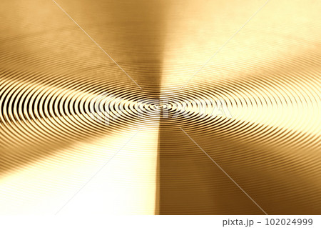 Texture of golden metal. Round metal texture. Metal texture background. Extrem close-up. Texture of golden metal. Round metal texture. Metal texture background. Extrem close-up. 102024999