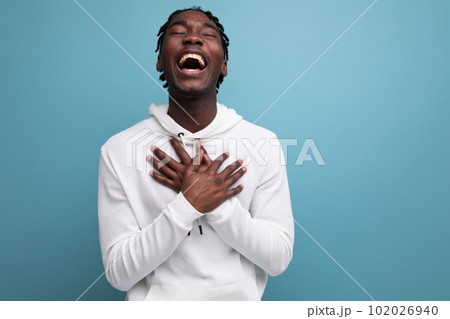 joyful winner african 20s man with dreadlocks on background with copy space joyful winner african 20s man with dreadlocks on background with copy space 102026940