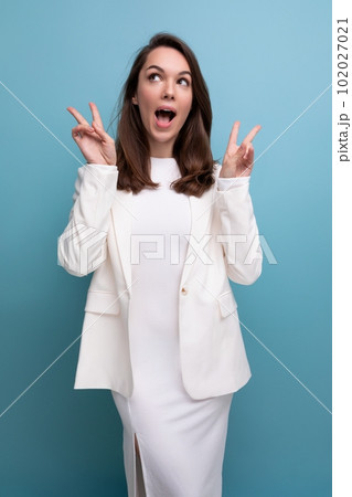portrait of pensive brunette woman in white dress looking up portrait of pensive brunette woman in white dress looking up 102027021