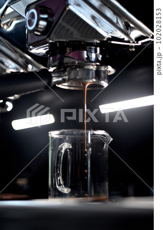 Coffee brew from espresso machine, Close up shot Coffee brew from espresso machine, Close up shot 102028153