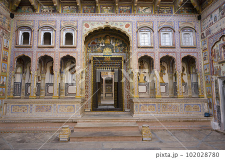 Colourful paintings and carved wooden door of Dr. Ramnath Podar Haveli Museum, a cultural heritage museum which houses Rajasthani living style, miniature paintings, textiles, jewellery, and other Colourful paintings and carved wooden door of Dr. Ramnath Podar Haveli Museum, a cultural heritage museum which houses Rajasthani living style, miniature paintings, textiles, jewellery, and other 102028780