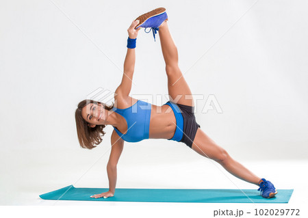 Sporty flexible girl doing stretching exercise Sporty flexible girl doing stretching exercise 102029772