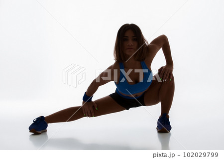 Sporty flexible girl doing stretching exercise Sporty flexible girl doing stretching exercise 102029799