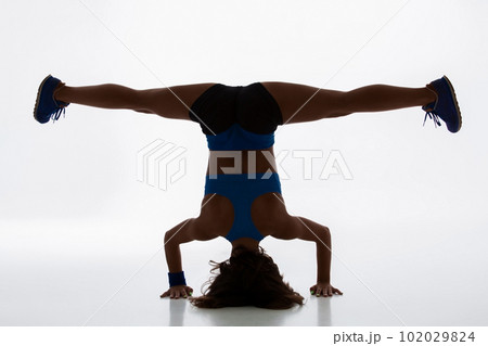 Sporty flexible girl doing stretching exercise Sporty flexible girl doing stretching exercise 102029824