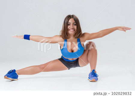 Sporty flexible girl doing stretching exercise 102029832