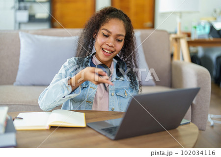 Portrait of African Americans using notebooks, pens to take notes and computers. to study through the Internet, online e learning concept Portrait of African Americans using notebooks, pens to take notes and computers. to study through the Internet, online e learning concept 102034116