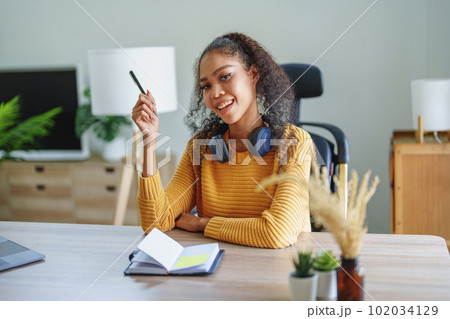 Portrait of African Americans using notebooks, pens to take notes and computers. to study through the Internet, online e learning concept Portrait of African Americans using notebooks, pens to take notes and computers. to study through the Internet, online e learning concept 102034129