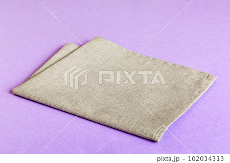 top view with gray kitchen napkin isolated on table background. Folded cloth for mockup with copy space, Flat lay. Minimal style top view with gray kitchen napkin isolated on table background. Folded cloth for mockup with copy space, Flat lay. Minimal style 102034313