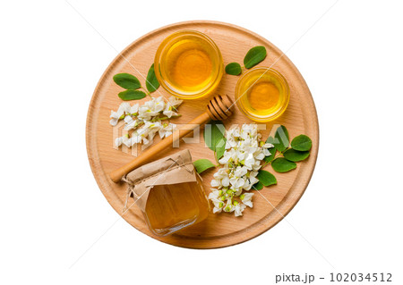 honey jar with acacia flowers and leaves isolated on white background. fresh honey top view flat lay honey jar with acacia flowers and leaves isolated on white background. fresh honey top view flat lay 102034512
