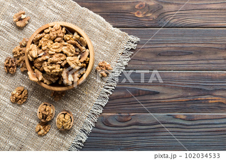 Fresh healthy walnuts in bowl on colored table background. Top view Healthy eating bertholletia concept. Super foods Fresh healthy walnuts in bowl on colored table background. Top view Healthy eating bertholletia concept. Super foods 102034533
