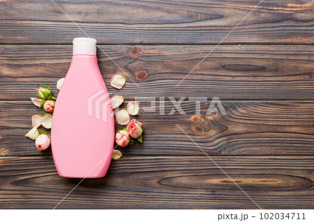 Fancy healthcare bottles for cream with rose flower. Natural oranic spa cosmetics concept. Mockup, template, Top view Fancy healthcare bottles for cream with rose flower. Natural oranic spa cosmetics concept. Mockup, template, Top view 102034711