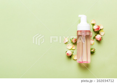 Fancy healthcare bottles for serum, micellar, tonic, toner, lotion, water and cream with rose flower. Natural oranic spa cosmetics concept. Mockup, template, Top view 102034712