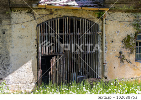 A historic gate of barn in a abandoned building A historic gate of barn in a abandoned building 102039753
