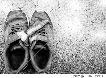 pair of worn out children's sneakers with scuffs damaged straps. pair of worn out children's sneakers with scuffs damaged straps. 102039951