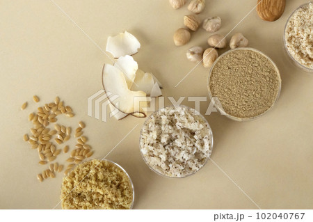 Beige background with gluten-free flax, coconut, chickpea, almond flour 102040767