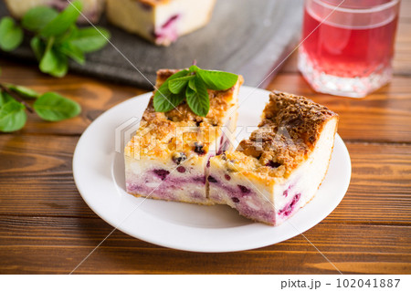 cooked cottage cheese casserole with berry filling in a plate 102041887