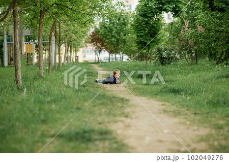 Inquisitive childhood. A little child boy outside looking far. Inquisitive childhood. A little child boy outside looking far. 102049276