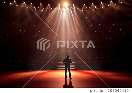 Fictional male artist on the big stage of an empty concert hall in the light of spotlights made with generative AI Fictional male artist on the big stage of an empty concert hall in the light of spotlights made with generative AI 102049419