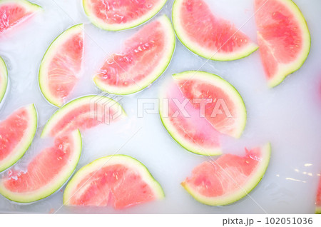 Turbid soapy water in bath with slices of watermelon. top view in full frame. The largest berry. spa with milk in the bath for rejuvenation.. Turbid soapy water in bath with slices of watermelon. top view in full frame. The largest berry. spa with milk in the bath for rejuvenation.. 102051036