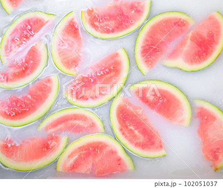 Turbid soapy water in bath with slices of watermelon. top view in full frame. The largest berry. spa with milk in the bath for rejuvenation.. Turbid soapy water in bath with slices of watermelon. top view in full frame. The largest berry. spa with milk in the bath for rejuvenation.. 102051037