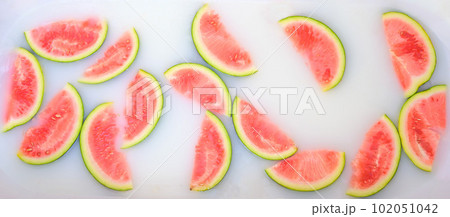 Turbid soapy water in bath with slices of watermelon. top view in full frame. The largest berry. spa with milk in the bath for rejuvenation.. Turbid soapy water in bath with slices of watermelon. top view in full frame. The largest berry. spa with milk in the bath for rejuvenation.. 102051042