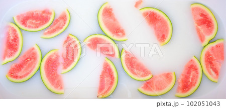Turbid soapy water in bath with slices of watermelon. top view in full frame. The largest berry. spa with milk in the bath for rejuvenation.. Turbid soapy water in bath with slices of watermelon. top view in full frame. The largest berry. spa with milk in the bath for rejuvenation.. 102051043