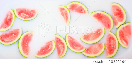 Turbid soapy water in bath with slices of watermelon. top view in full frame. The largest berry. spa with milk in the bath for rejuvenation.. Turbid soapy water in bath with slices of watermelon. top view in full frame. The largest berry. spa with milk in the bath for rejuvenation.. 102051044