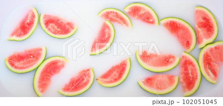 Turbid soapy water in bath with slices of watermelon. top view in full frame. The largest berry. spa with milk in the bath for rejuvenation.. Turbid soapy water in bath with slices of watermelon. top view in full frame. The largest berry. spa with milk in the bath for rejuvenation.. 102051045