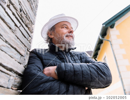 Portrait of a confident, handsome, mature man, pensioner, grandfather in the small town Portrait of a confident, handsome, mature man, pensioner, grandfather in the small town 102052005
