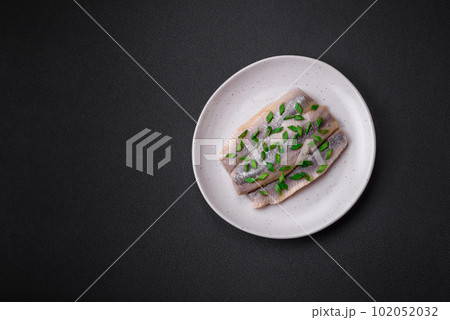Delicious Atlantic herring marinated with salt and spices 102052032