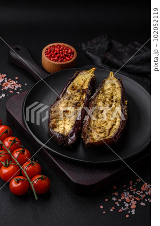 Delicious eggplant cut into two halves baked with salt, spices and herbs 102052119