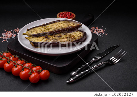Delicious eggplant cut into two halves baked with salt, spices and herbs 102052127