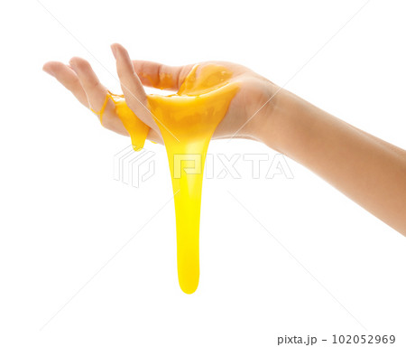 Woman playing with yellow slime isolated on white, closeup. Antistress toy 102052969