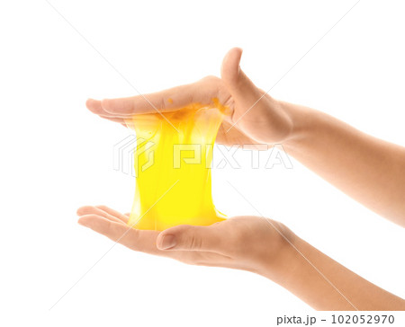 Woman playing with yellow slime isolated on white, closeup. Antistress toy Woman playing with yellow slime isolated on white, closeup. Antistress toy 102052970
