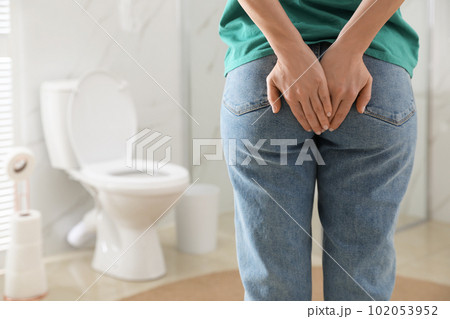 Woman suffering from hemorrhoid in rest room, closeup 102053952