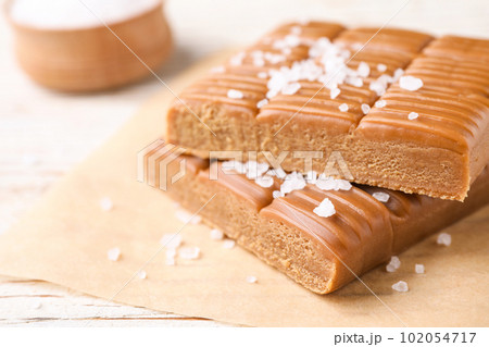 Salted caramel on white wooden table, closeup Salted caramel on white wooden table, closeup 102054717